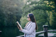 © jozzeppe777 - Beautiful young brunette woman in autumn park, reading a book