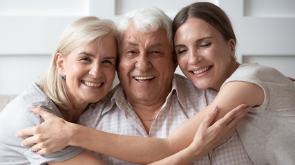 Wall Mural - closeup portrait old father middle-aged mother adult daughter