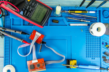 Canvas Print - The electrician's workplace. Schemes, soldering iron. Electronics