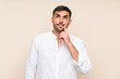 © luismolinero - Handsome man with beard over isolated background thinking an idea