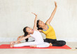 © sutlafk - Beautiful young asia woman and her charming little daughter are smiling while doing yoga together at home