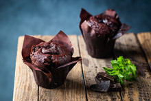 Dark Chocolate Muffin With Mint On A Wooden Table, Homemade Baking