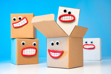 Emoji. Cardboard boxes have faces. Parcels await delivery. Gifts want to be unpacked. Closed-box envy. The joy of receiving a gift. Long delivery of parcels.