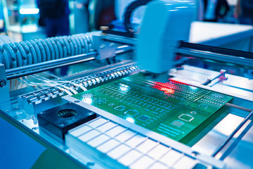 Poster - Fragment of the CNC machine. Equipment for PCB Assembly. Production automation. The robot fixes the electronic components on the Board in accordance with the specified program.
