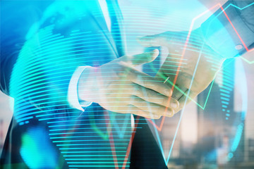 Double exposure of financial chart and world map on cityscape background with two businessmen handshake. Concept of international investment