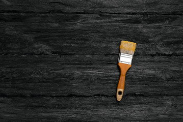 Paint brush on black wooden board flat lay background with a copy space.