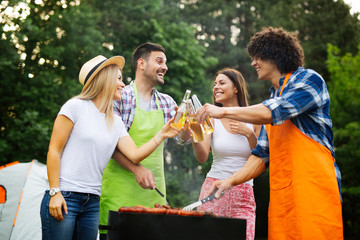 Group of happy friends having outdoor barbecue party and fun together