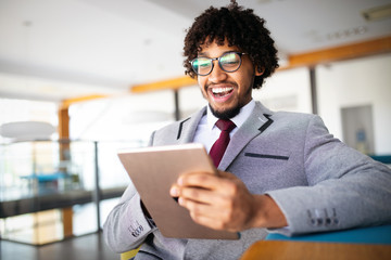 Portrait of man in office using tablet