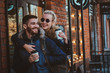 © Fxquadro - Cheerful smiling couple is enjoying their coffee outside cozy cafeteria, woman is hugging her man.