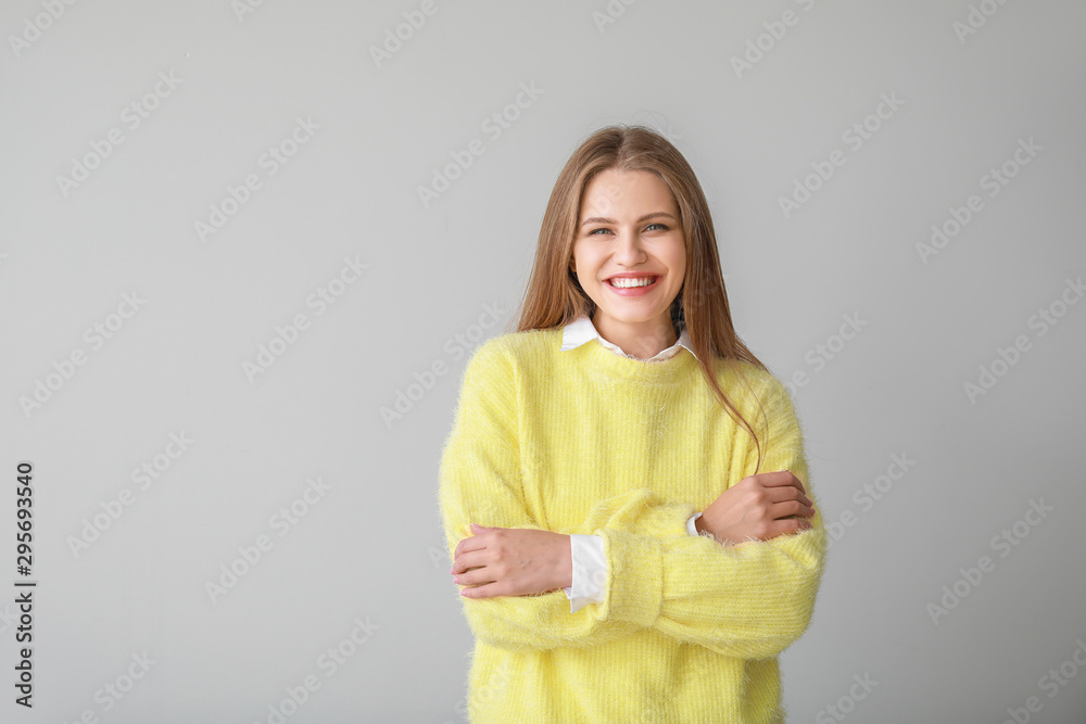 Portrait of beautiful woman on grey background