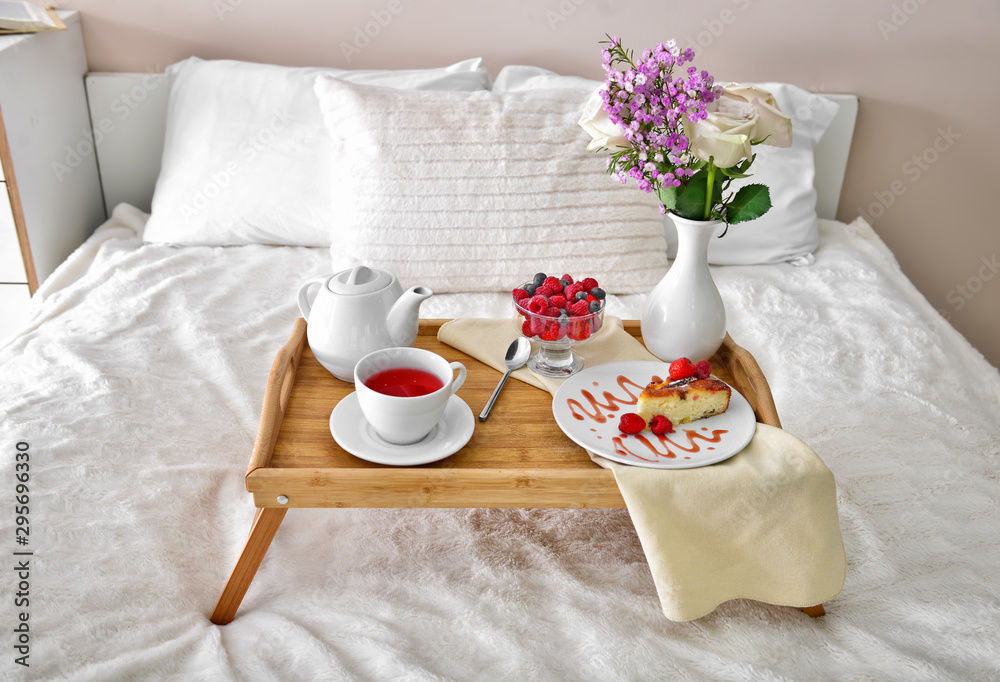 Tray table with tasty breakfast on bed