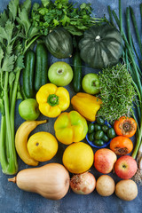 Sticker - Vegetables and fruits in green-yellow tones on a blue background. View from above. Healthy eating concept.