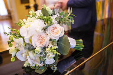 bright wedding bouquet of summer white pink roses  with wedding rings