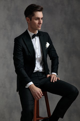 Poster - fashion elegant groom wearing tuxedo and looking to side