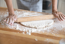 Woman Rolls Out Dough With Rolling Pin Close Up