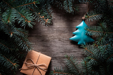 Wall Mural - A frame of fir branches and  gift paper box tied with twine. Christmas card blank.