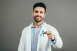 Prostate Cancer Awareness. Doctor man holding light Blue Ribbon for supporting people living and illness. Men Healthcare and World cancer day concept