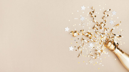 celebration background with golden champagne bottle, confetti stars and party streamers. christmas, 