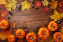 Autumn Thanksgiving Background. Pumpkins, Acorns And Leaves On Wooden Table Top View.