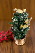 Small christmas tree with golden and red ornaments, Christmas decoration on wooden background