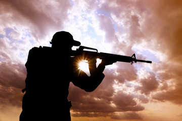 Wall Mural - Soldier with machine gun patrolling outdoors. Military service