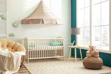 Poster - Cute nursery interior with comfortable crib near white wall