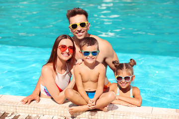 Poster - Happy family in swimming pool on sunny day