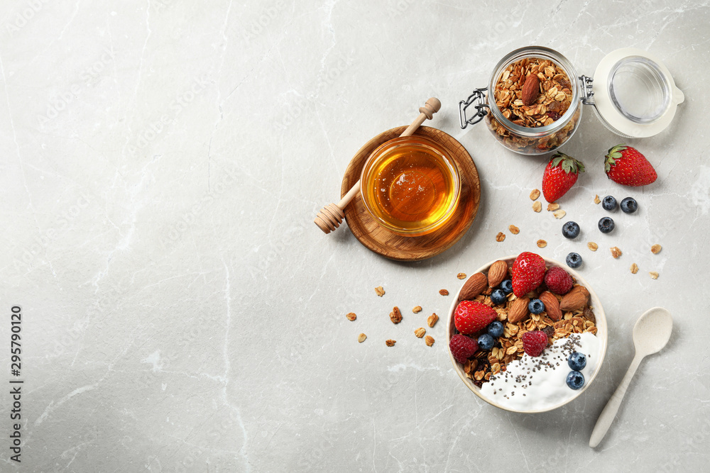 Tasty homemade granola served on marble table, flat lay with space for text. Healthy breakfast - obrazy, fototapety, plakaty 