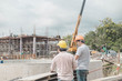 Two young man architect on a building construction site