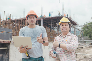 Two young man architect on a building construction site