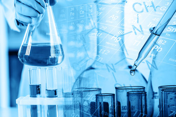 Wall Mural - hand of scientist holding flask with lab glassware and test tubes in chemical laboratory background,