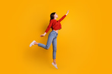 Full Length Photo Of Positive Cheerful Lovely Girl Jump Hold Hand Want Catch Her Flying Parasol Star Wear Good Looking Clothing Isolated Over Yellow Color Background