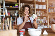 © pikselstock - Craftswoman painting a bowl made of clay in art studio