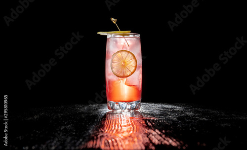 Fotomural Alcoholic cocktail with juice garnished with cherry and jalapeno pepper planted for a long time