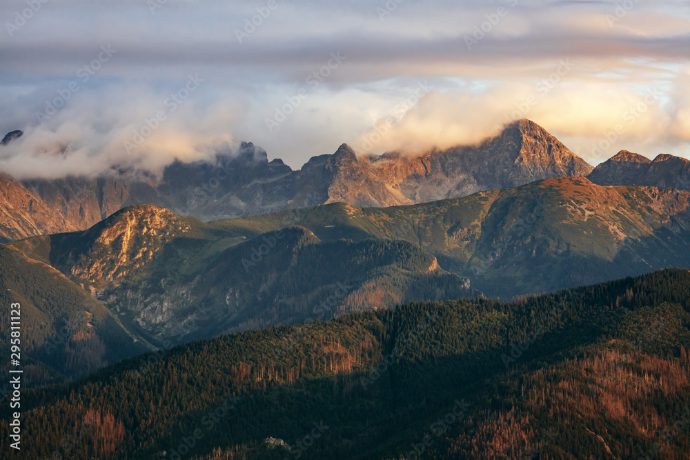 Mountain peaks in clouds at sunset. Tatra Mountains, Poland - obrazy, fototapety, plakaty 