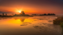 Misty Orange Sunrise Over The Lake. Seasonal Autumn Colors