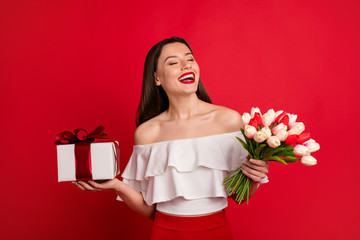 Wall Mural - Portrait of her she nice-looking attractive glamorous chic lovely lovable winsome cheerful cheery lady holding in hands presents isolated over bright vivid shine red background