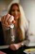 © JustLife - Young female agent holding a key