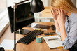 © JustLife - Young businesswoman overworked. Tired woman having headache.