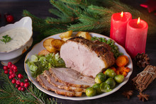 Roasted Sliced Ham On White Plate, Table With Christmas Decorations. Dish For Christmas Eve. Winter Season Holidays Food