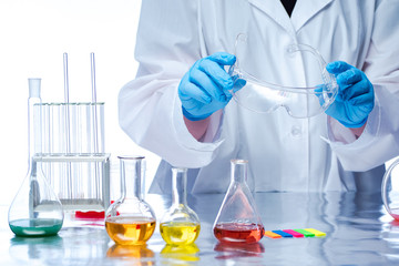 Poster - Hands reach for the minzurs. Medicinal substances. Hands of a man next to the clefts. Pharmacotherapy. Flasks on the laboratory table. Making Potions. Production on the individual recipe.