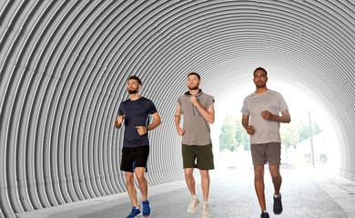 Wall Mural - fitness, sport and healthy lifestyle concept - young men or male friends running outdoors