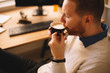 © JustLife - Close up of businessman drinking coffee