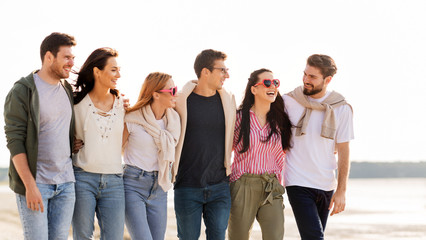 Poster - friendship, leisure and people concept - group of happy friends walking along beach in summer