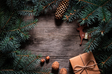 Wall Mural - A frame of fir branches and  gift paper box tied with twine. Christmas card blank.