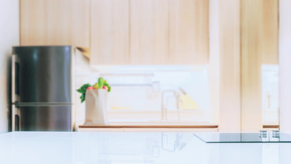 white glossy counter top and blur kitchen room background