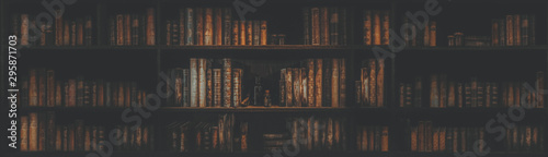Fotomural panorama blurred bookshelf Many old books in a book shop or library