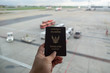 hand holding Thailand passport on airport background