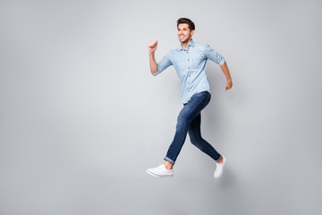 Sticker - Full length body size photo of cheerful handsome attractive guy wearing white sneakers isolated over grey color background running towards his dream