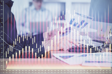 Aufkleber - Double exposure of graph with man typing on computer in office on background. Concept of hard work. Closeup.